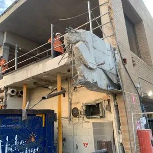 Concrete demolition access work on building facade
